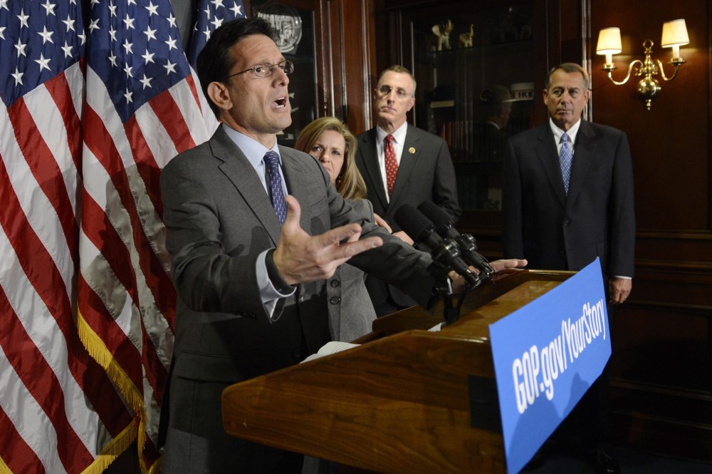 House Majority Leader Republican Eric Cantor (L) holds a news conference with other House Republicans following a Republican caucus meeting on Capitol Hill in Washington D.C., October 23, 2013.
