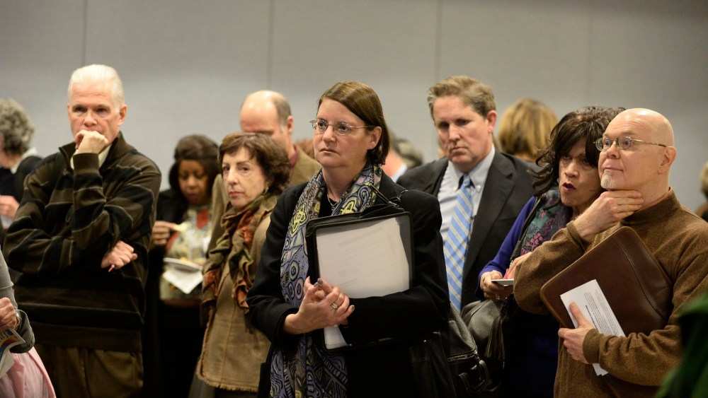 Potential job seekers speak with employers at a job fair in New York, New York, November 20, 2013..