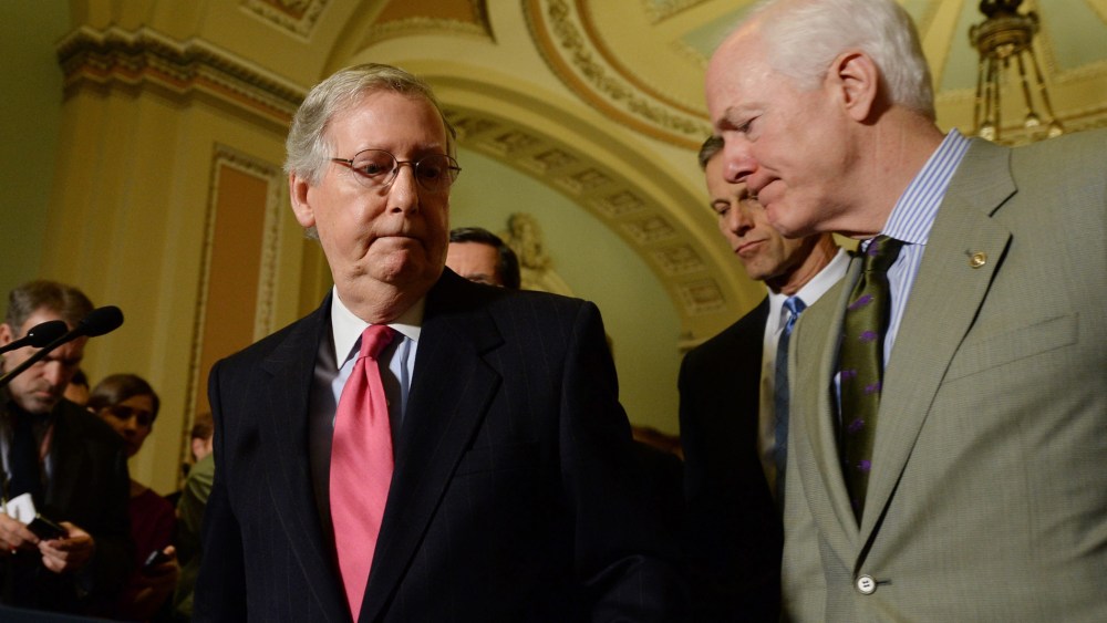 Senate Minority Leader, Republican from Kentucky Mitch McConnell (L), turns away from the podium beside Republican Senator from Texas John Cornyn (R), during a news conference on Capitol Hill in Washington, D.C., January 14, 2014.