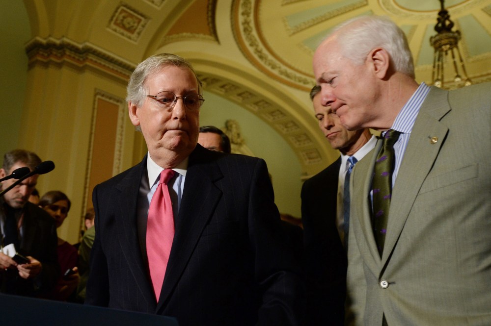 Senate Minority Leader, Republican from Kentucky Mitch McConnell (L), turns away from the podium beside Republican Senator from Texas John Cornyn (R), during a news conference on Capitol Hill in Washington, D.C., January 14, 2014.