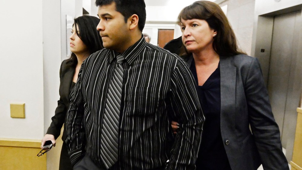 Erick Muñoz, husband of Marlise Muñoz walks into the Tarrant County court house with attorneys in Fort Worth, Texas, USA, Jan. 24, 2014.