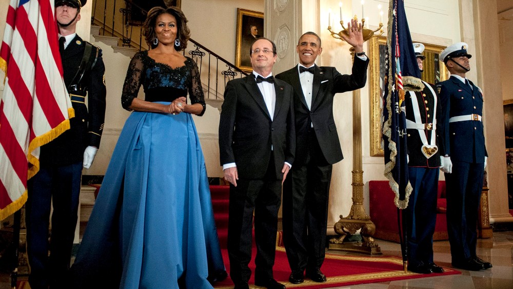 US President Barack Obama and First Lady Michelle Obama pose for a photo with President Francois Hollande of France on the Grand Staircase in the White House in Washington on Feb. 11, 2014.