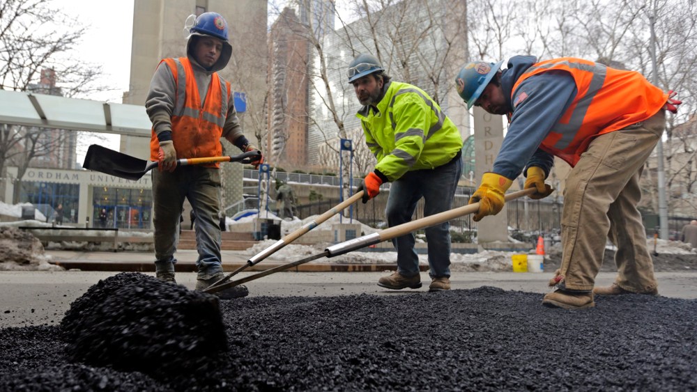 Work crews repair potholes on Columbus Avenue in New York City, New York, February 20, 2014.