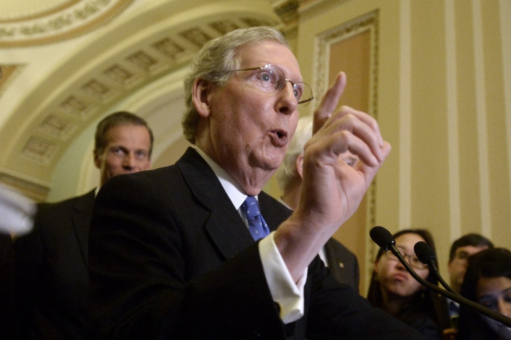 Senate Minority Leader Republican Mitch McConnell responds to a question on Capitol Hill in Washington D.C., March 25, 2014.