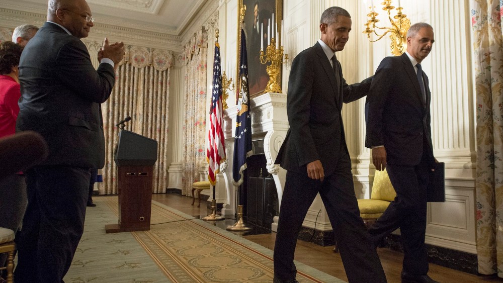 US President Barack Obama (2-R) and US Attorney General Eric Holder (R) walk away from the podium after they delivered remarks on Holder's resignation, at the White House, in Washington on Sept. 25, 2014.