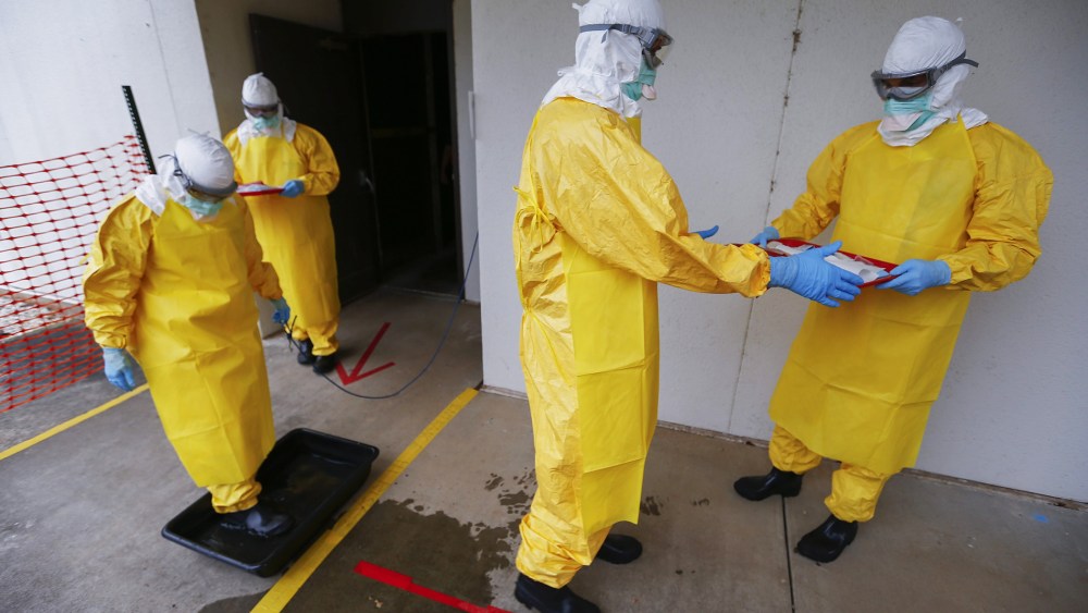Students wearing personal protective equipment participate in a Centers for Disease Control and Prevention training session facility for healthcare workers treating Ebola virus victims in Anniston, Ala., on Oct. 15, 2014.