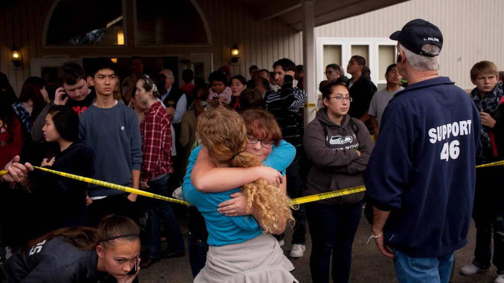 Students gather with parents and at Shoults Gospel Hall in Marysville, Wash. on Oct. 24, 2014, after a school shooting that occured at the Marysville-Pilchuck High School nearby.