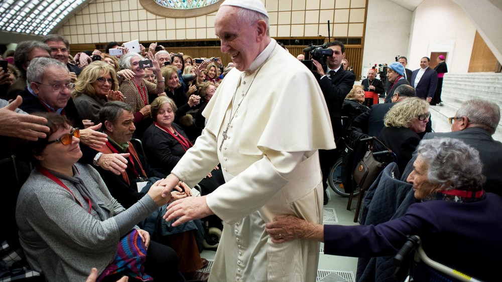 Pope Francis (C) greets people during his audience with members of the Italian Catholic Doctors' Association at the Vatican on Nov. 15, 2014.