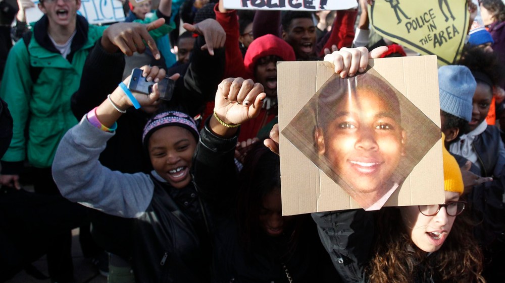 Protesters carry a photo of Tamir Rice as they march during a rally at Public Square in Cleveland, Ohio, Nov. 24, 2014.