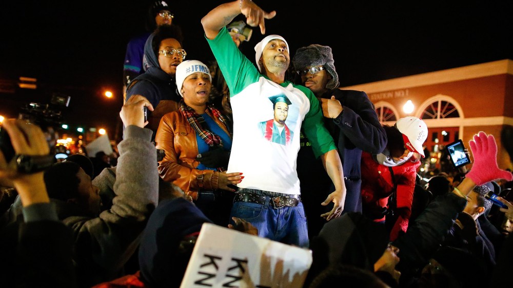 The mother of Michael Brown, Lesley McSpadden, (2-L) and her husband Louis Head gesture after the announced decision by the Grand Jury in Ferguson Mo. on Nov. 24, 2014.