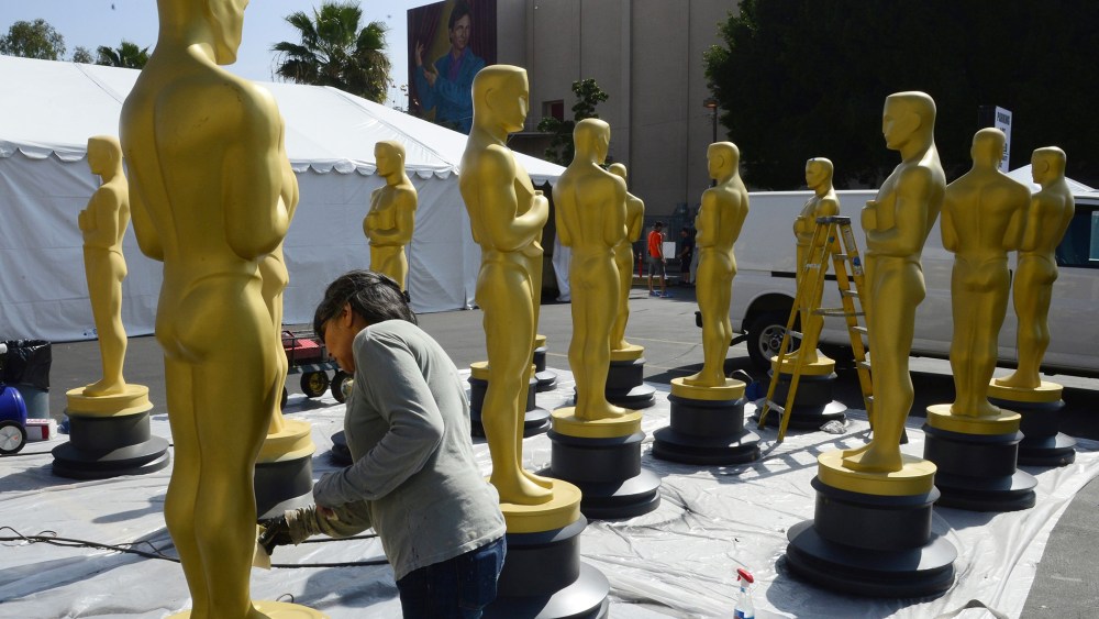 Virginia Belloni touches up Oscar statues as preparations for the 87th annual Academy Awards ceremony get underway in Hollywood, Calif. on Feb. 18, 2015.