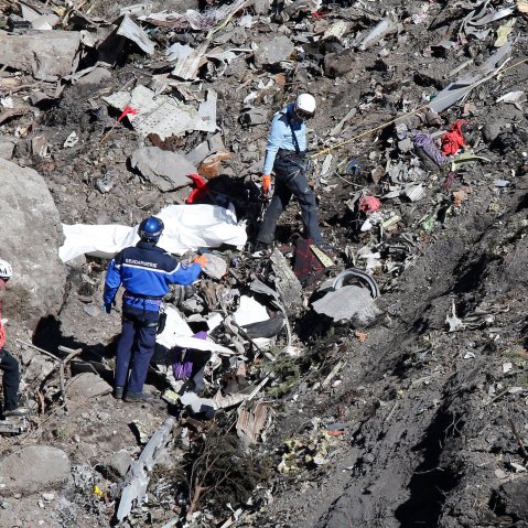 Search and rescue workers make their way through debris at the crash site of the Germanwings Airbus A320 that crashed in the French Alps, above the town of Seyne-les-Alpes, southeastern France on March 26, 2015.