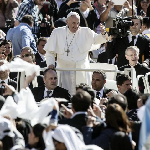 Pope Francis followers as he arrives in St. Peter's Square for his weekly general audience, in the Vatican City on April 22, 2015.