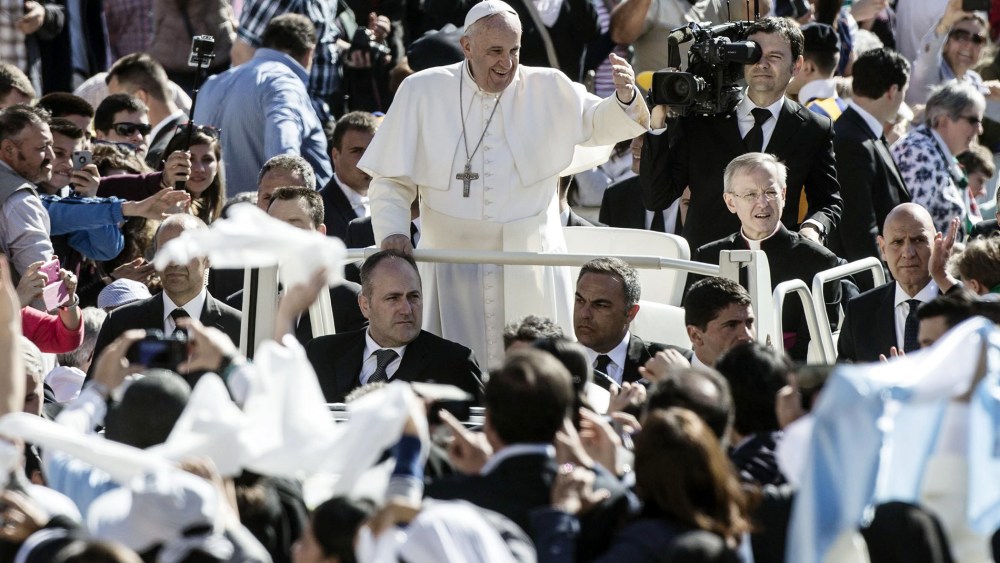 Pope Francis followers as he arrives in St. Peter's Square for his weekly general audience, in the Vatican City on April 22, 2015.