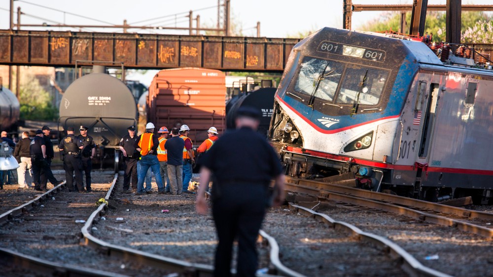 The remains of an Amtrak train that derailed on its way from Washington, D.C., to New York City are seen just outside Philadelphia, Pa., on May 13, 2015. (Photo by Jim Lo Scalzo/EPA)