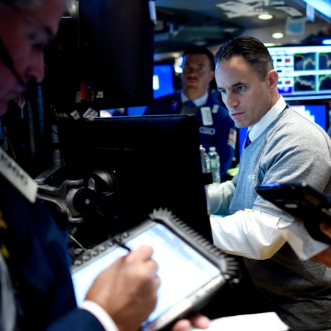 Traders work on the floor of the New York Stock Exchange at the start of the trading day in New York, N.Y., Aug. 25, 2015. (Photo by Justin Lane/EPA)