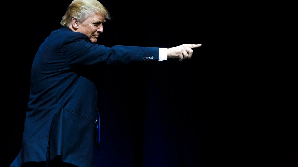 Republican presidential candidate Donald Trump points at supporters after speaking at rally at the Verizon Wireless Center in Manchester, N.H., on Feb. 8, 2016. (Photo by Justin Lane/EPA)