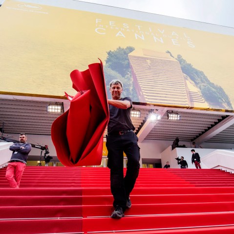 A worker installs the red carpet in front of the Festival Palace ahead of the 69th Cannes Film Festival, in Cannes, France, May 10, 2016. (Photo by Julien Warnand/EPA)