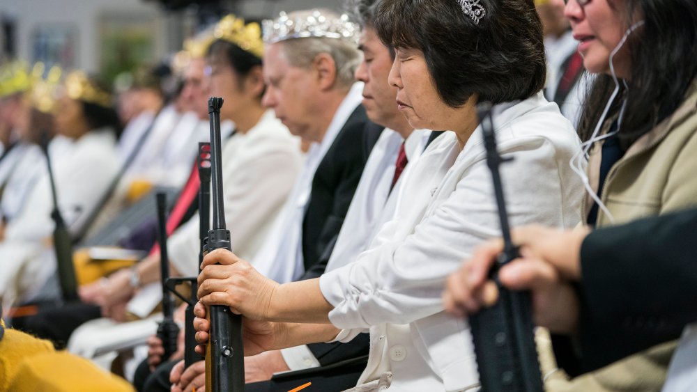 Parishioners with the Sanctuary Church hold onto their AR-15s, which churchgoers were encouraged to bring to a blessing ceremony to rededicate their marriages, at the World Peace and Unification Sanctuary in Newfoundland, Pennsylvania, USA, 28 February 20