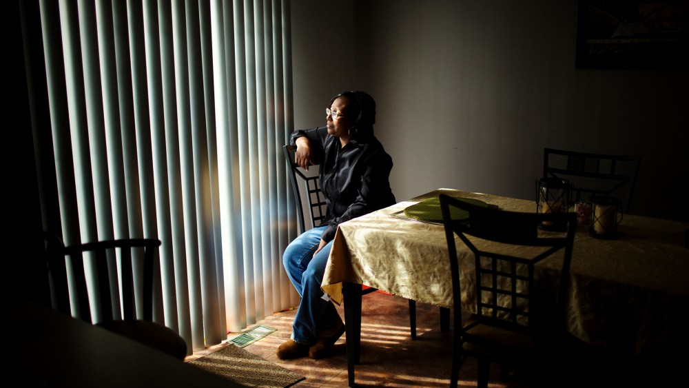 Renee Brooks looks out of the window in her home in District Heights, Maryland.