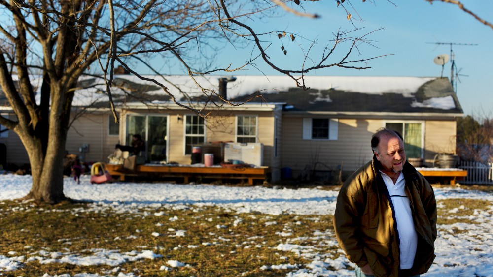 Paul Moody stands in the backyard of his home.