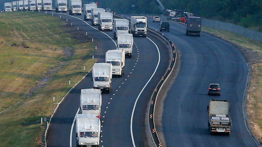 A Russian convoy of trucks carrying humanitarian aid for Ukraine travels along a road south of the city of Voronezh