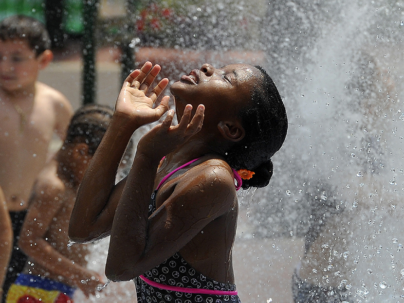 Children cool off during a hot summer day at a fountain in downtown Silver Spring, Maryland, on July 19, 2013. (Photo by Jewel Samad/AFP/Getty Images)