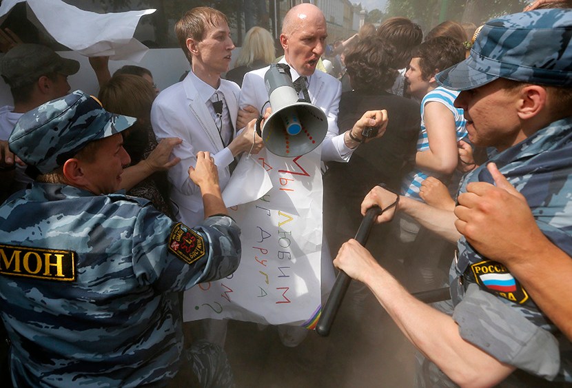 Riot police (OMON) officers detain gay rights activists Maxim Lysak and Jury Gavrikov during an authorized gay rights rally in St.Petersburg, Russia, Saturday, June 29, 2013.  (Photo by Dmitry Lovetsky/AP)