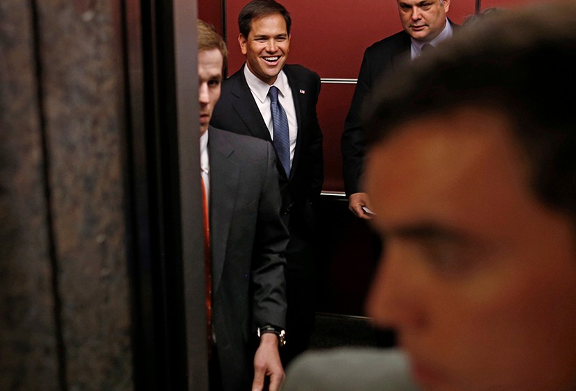 Sen. Marco Rubio, R-Fla. center, smiles from inside an elevator as he leaves reporters who were following him behind after he spoke at the Faith and Freedom Coalition Road to Majority Conference in Washington, Thursday, June 13, 2013. (Photo by Charles...