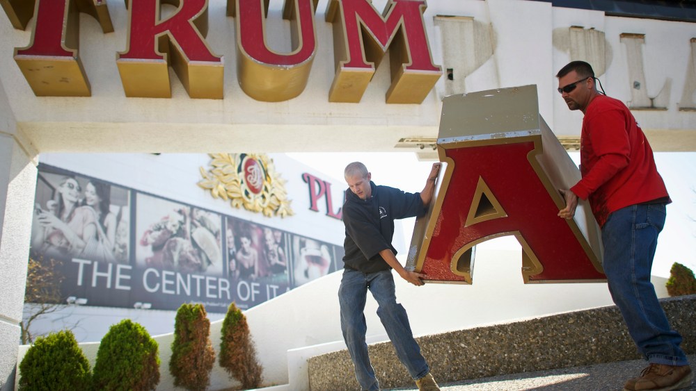 Nordaby and Demidio, of Calvi Electric, remove the letter 'A' from the signage of Trump Plaza Casino in Atlantic City, New Jersey