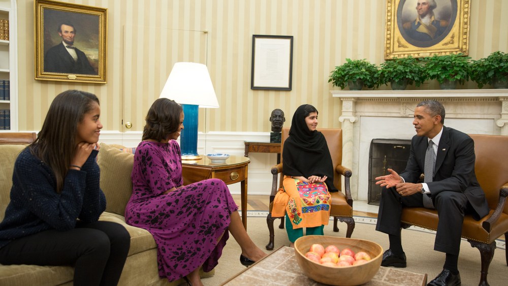 President Barack Obama, First Lady Michelle Obama, and their daughter Malia meet with Malala Yousafzai, the young Pakistani schoolgirl who was shot in the head by the Taliban a year ago, in the Oval Office, Oct. 11, 2013.