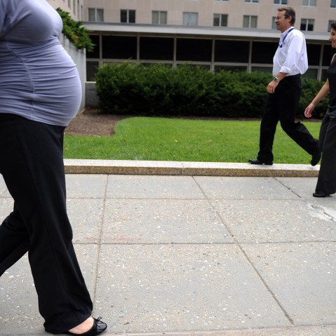 A pregnant woman walks outside the State Department on Aug. 5, 2010 in Washington, DC.