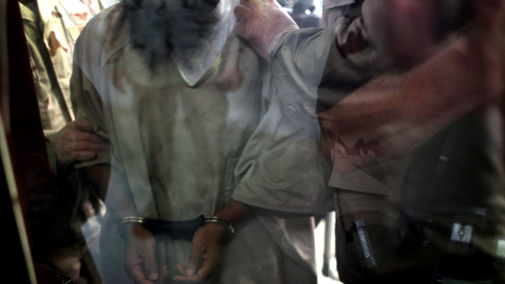 U.S. military guards move a detainee inside the detention center for "enemy combatants" on Sept. 15, 2010 in Guantanamo Bay, Cuba.