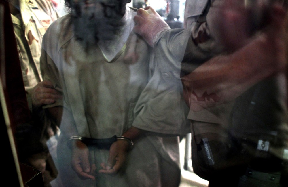U.S. military guards move a detainee inside the detention center for "enemy combatants" on Sept. 15, 2010 in Guantanamo Bay, Cuba.