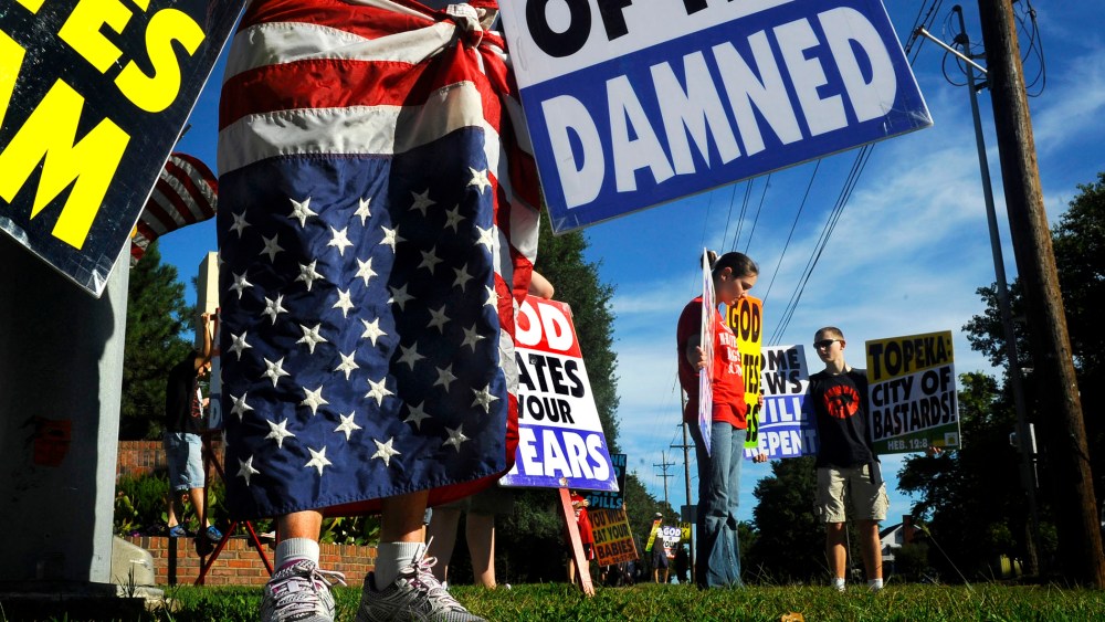Members of the Westboro Baptist Church picket at a city park near their church in Topeka, KS.