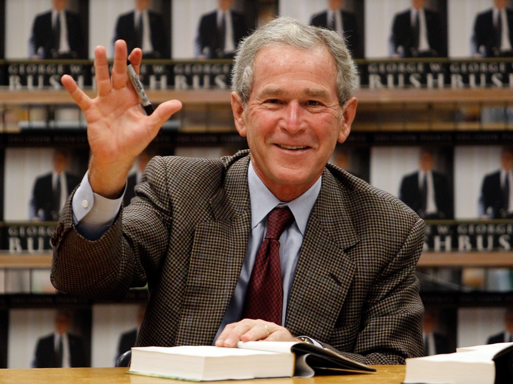 File Photo: Former U.S. President George W. Bush waves while signing copies of his new memoir "Decision Points" at Borders Books on November 9, 2010 in Dallas, Texas. (Photo by Tom Pennington/Getty Images/File)