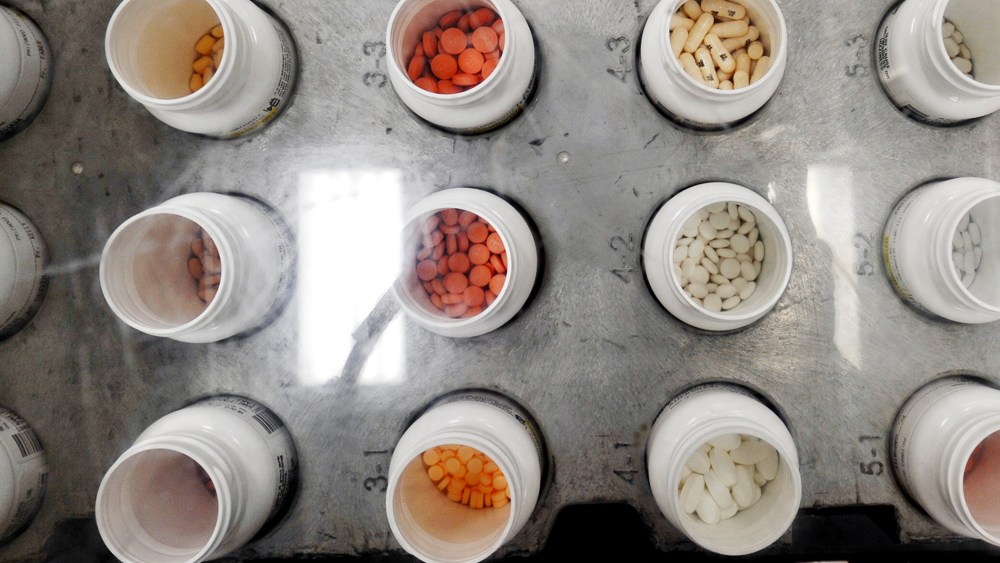Bottles of prescription pills go through an automated packaging machine in the Medco pharmacy plant in Willingboro, New Jersey.