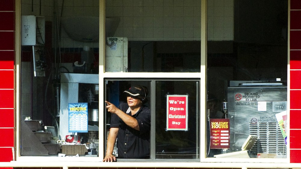 A woman working the drive-thru window at a Burger King restaurant in Kaneohe Bay, Hawaii.