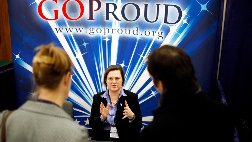 Participants talk with a representatives from GOProud, an organization that represents gay conservatives and their allies, at a Conservative Political Action Conference.