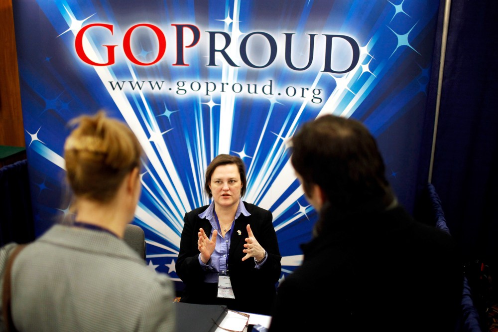 Participants talk with a representatives from GOProud, an organization that represents gay conservatives and their allies, at a Conservative Political Action Conference.