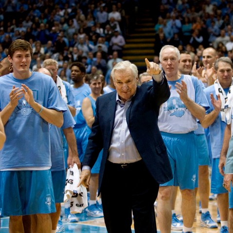Surrounded by decades of former University of North Carolina players, coach Dean Smith receives a standing ovation after being honored during the Celebration of a Century in Chapel Hill, NC, Feb. 12, 2010. (Photo by Robert Willett/MCT via Getty)