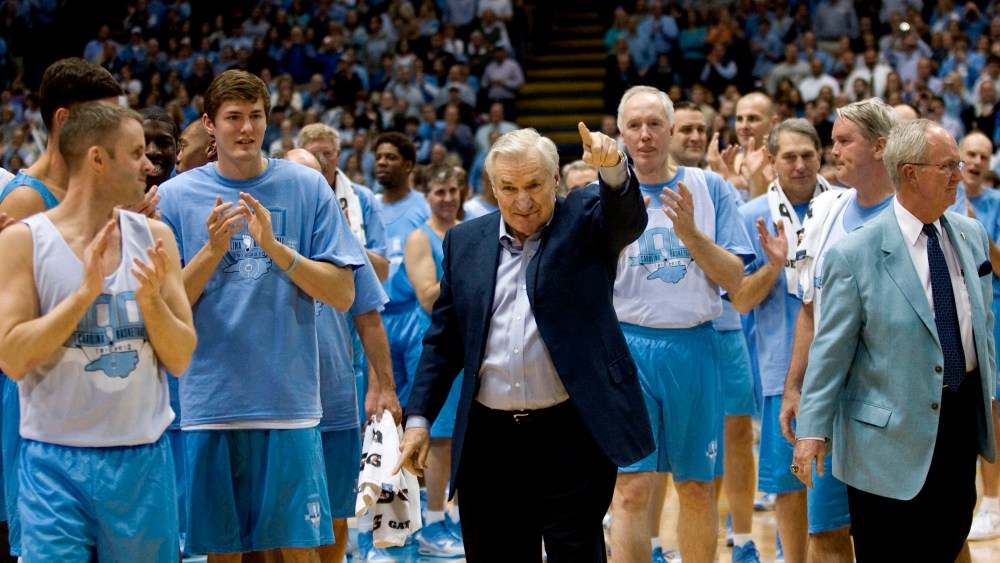 Surrounded by decades of former University of North Carolina players, coach Dean Smith receives a standing ovation after being honored during the Celebration of a Century in Chapel Hill, NC, Feb. 12, 2010. (Photo by Robert Willett/MCT via Getty)