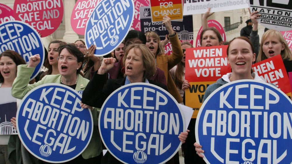 Abortion rights activist take part in a demonstration outside the Supreme Court in Washington, Wednesday, April 18, 2007.