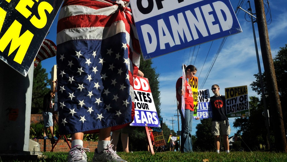 Members of the Westboro Baptist Church picket a city park near their church in Topeka, Kan.