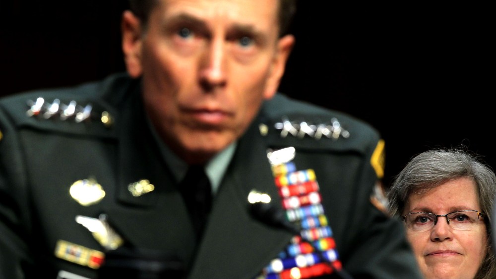 File Photo: U.S. Gen. David Petraeus (L) listens as his wife Holly Petraeus (R) looks on during a confirmation hearing before the Senate (Select) Intelligence Committee June 23, 2011 on Capitol Hill in Washington, DC. (Photo by Alex Wong/Getty Images)