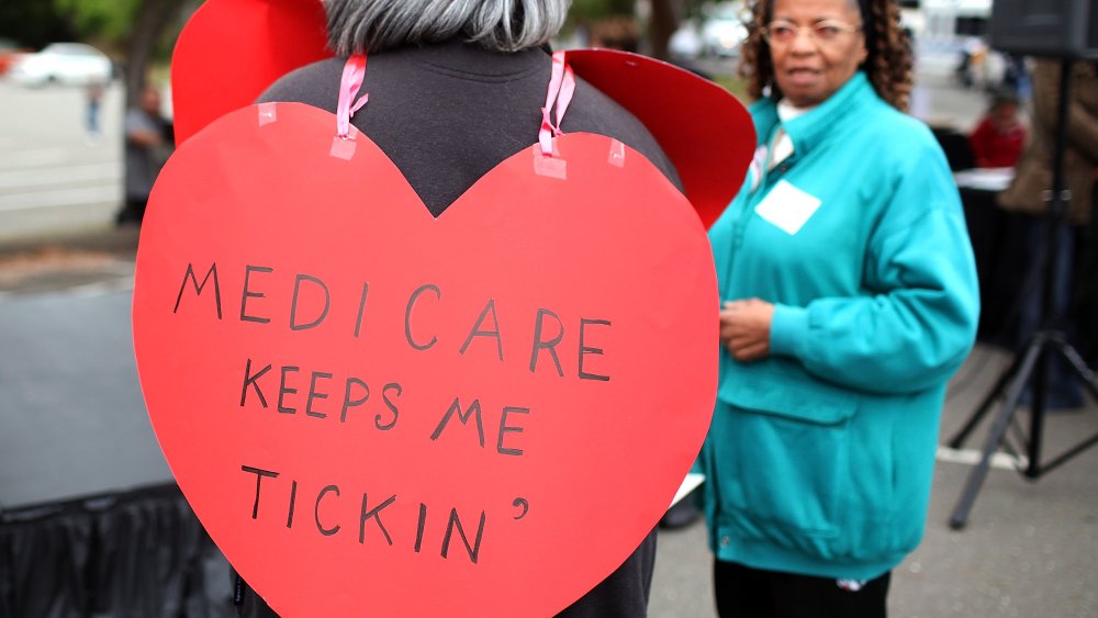 A senior citizen holds a sign during a rally to protect federal health programs at the 8th Annual Healthy Living Festival on July 15, 2011 in Oakland, California.