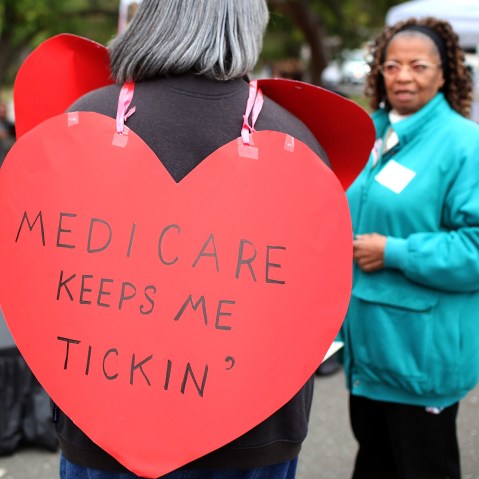 File Photo: A senior citizen holds a sign during a rally to protect federal health programs at the 8th Annual Healthy Living Festival on July 15, 2011 in Oakland, California.  (Photo by Justin Sullivan/Getty Images/FIle)