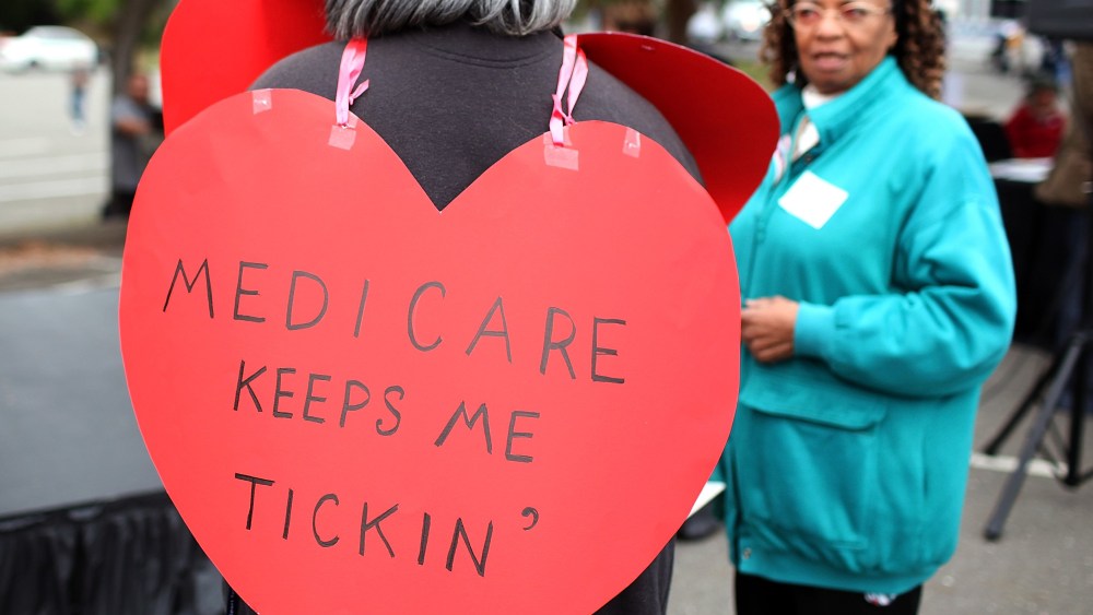 File Photo: A senior citizen holds a sign during a rally to protect federal health programs at the 8th Annual Healthy Living Festival on July 15, 2011 in Oakland, California.  (Photo by Justin Sullivan/Getty Images/FIle)