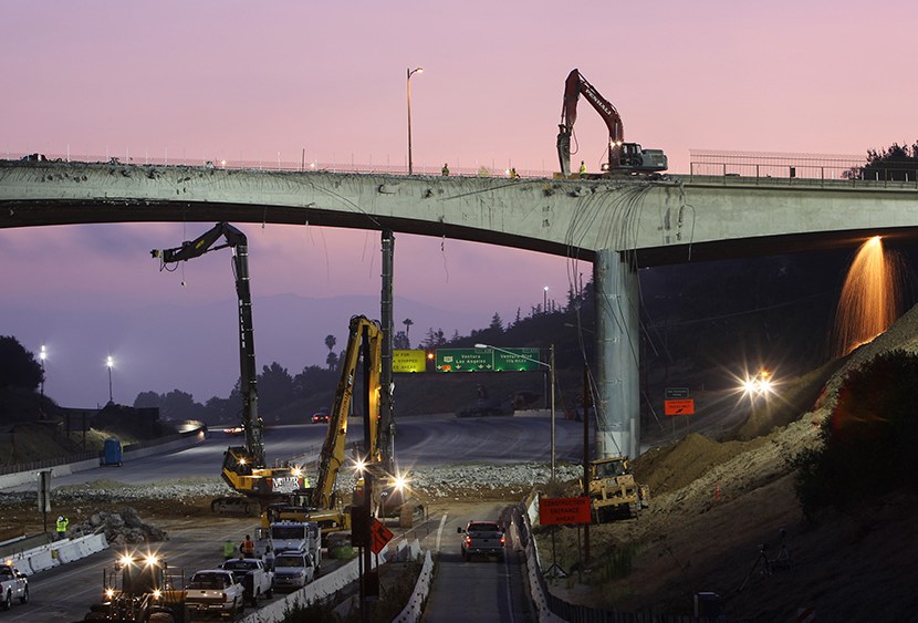 Workers demolish the south side of Mulholland overpass on the 405 freeway during the 53-hour total freeway closure resulting in massive traffic disruptions expected throughout the region on July 16, 2011 in Los Angeles, California.  (Photo by David...