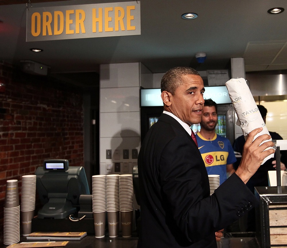 WASHINGTON, DC - MAY 16:  U.S. President Barack Obama holds up a hoagie he purchased after visiting Taylor Gourmet, a sandwich restaurant, May 16, 2012 in Washington, DC. Obama is urging Congress to act on his "To Do List," specifically highlighting...
